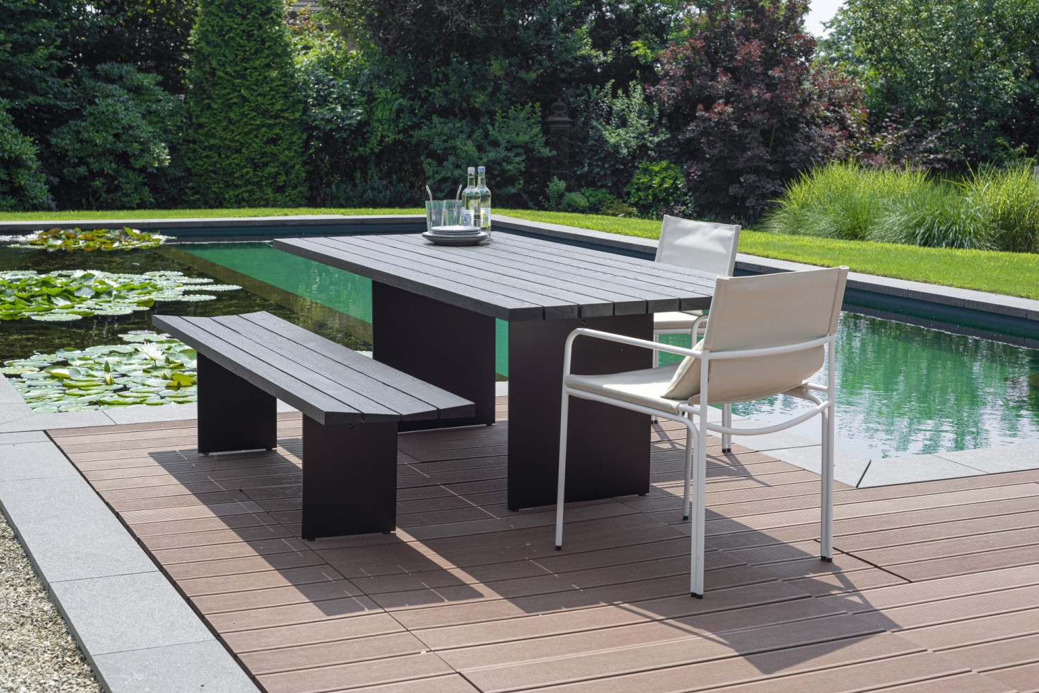 Duo outdoor bench and table in black by the private natural pool