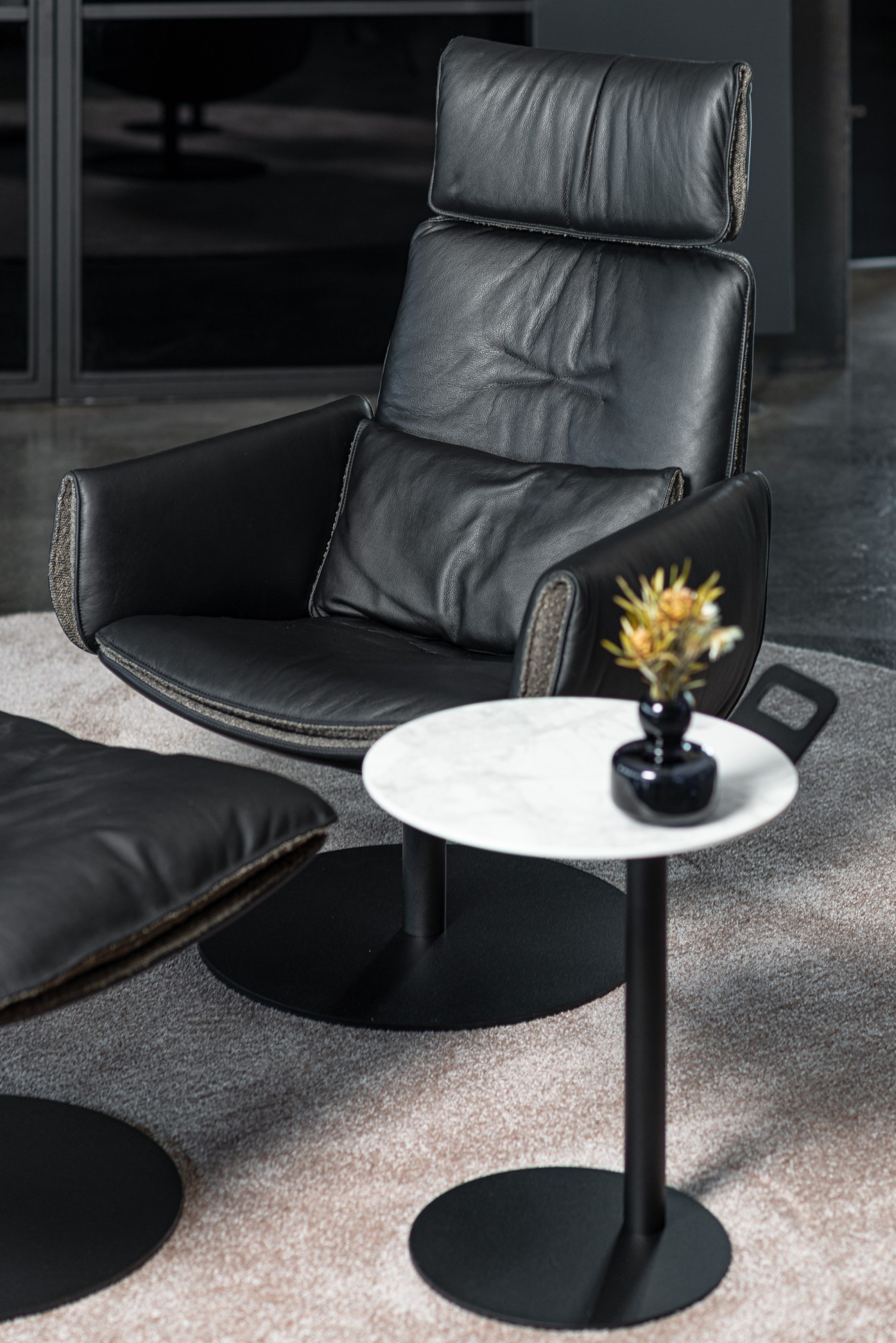 CADO LOUNGE Edition armchair and ottoman in  black leather with ASCO Disc side table