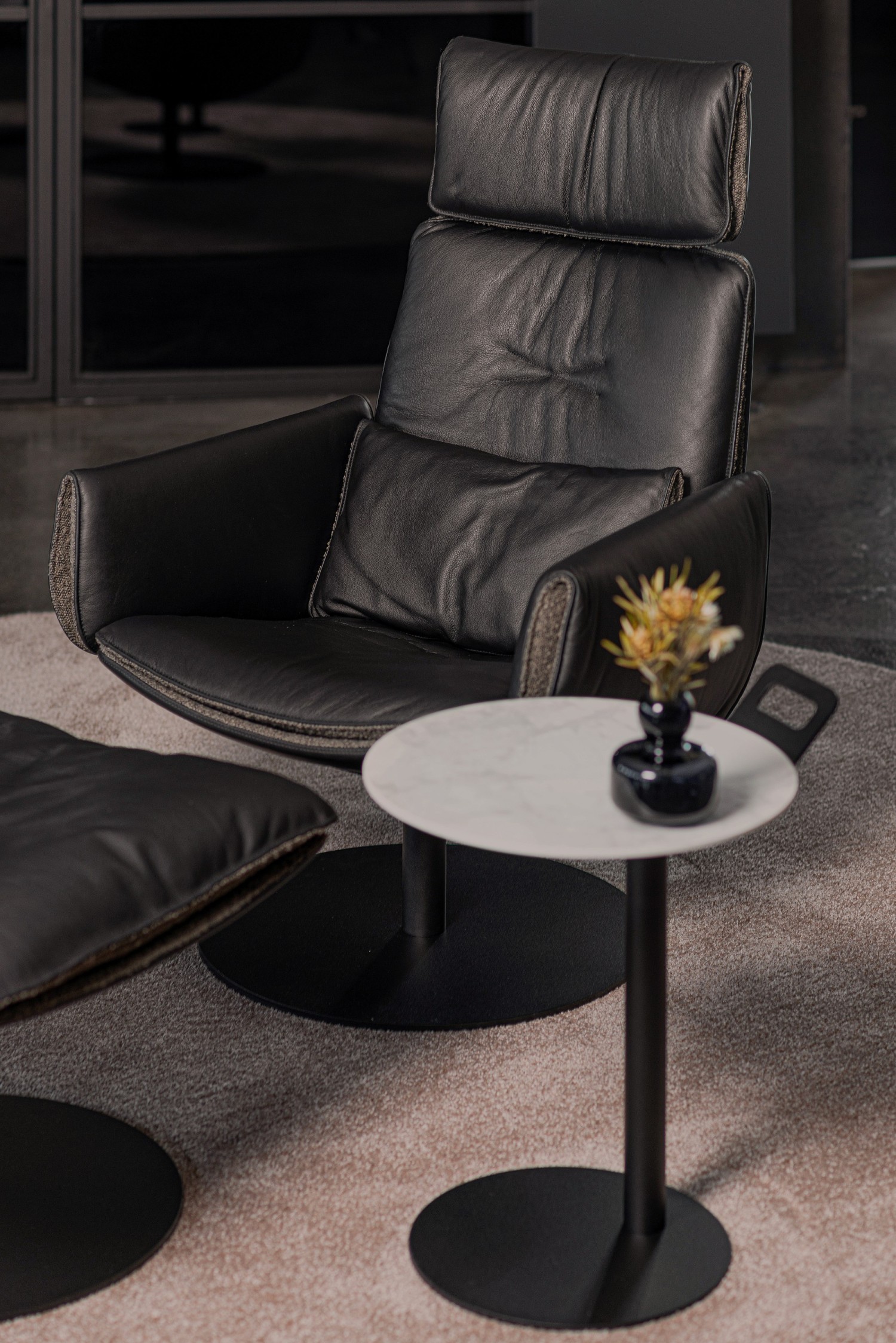 CADO LOUNGE Edition armchair and ottoman in black leather with ASCO Disc side table